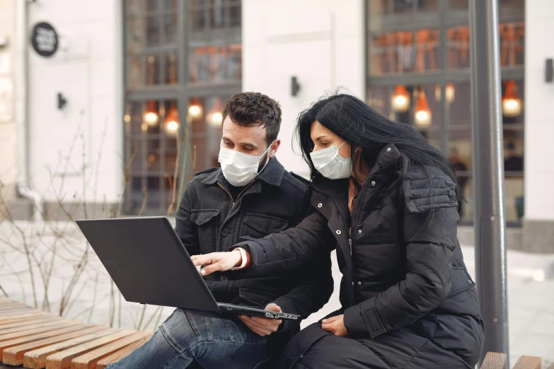 a couple of people sitting on a bench with a laptop, dust mask, instagram picture, healthcare, thumbnail