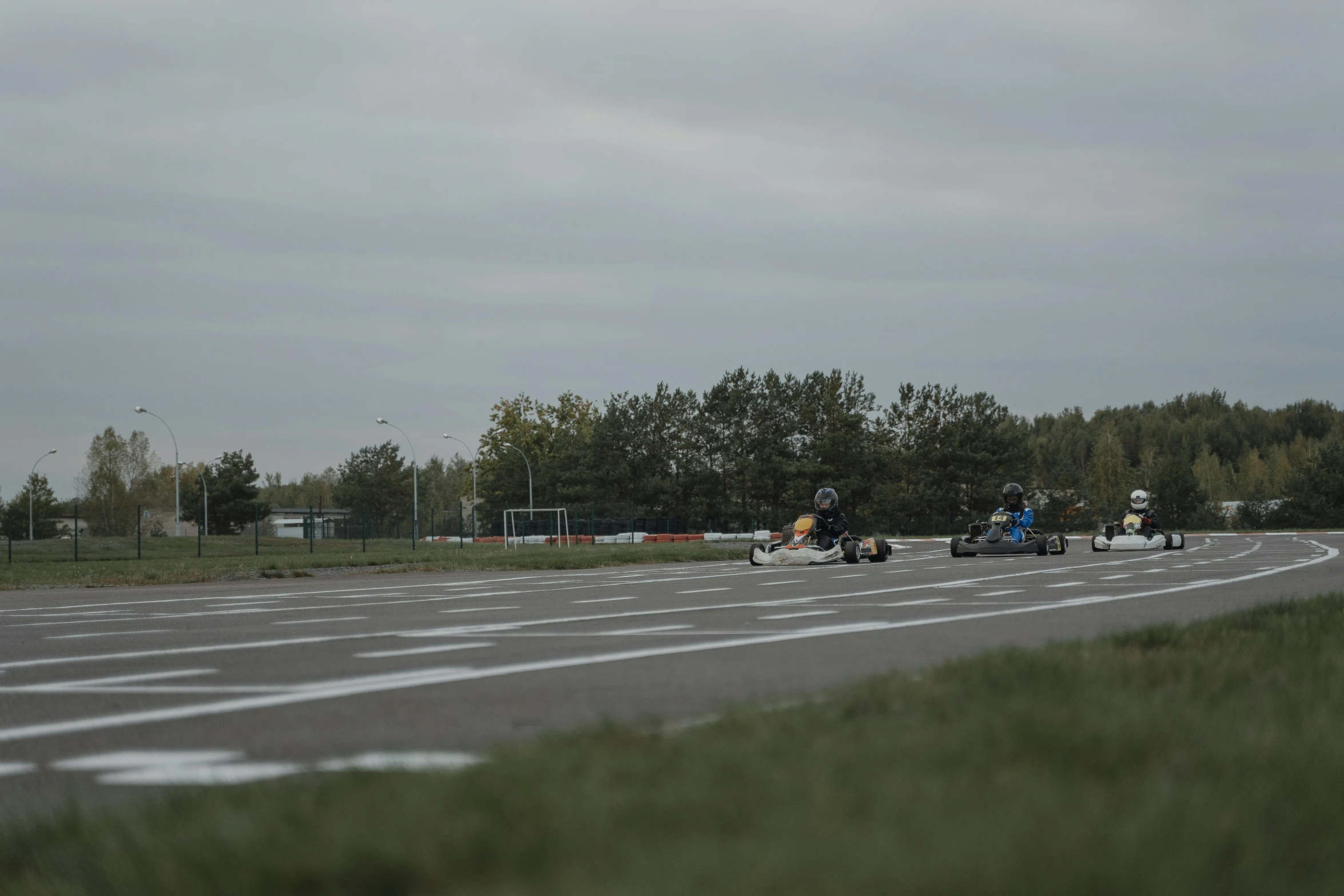 a group of people riding motorcycles down a road, airport, people resting on the grass, tjalf sparnaay 8 k, fall season