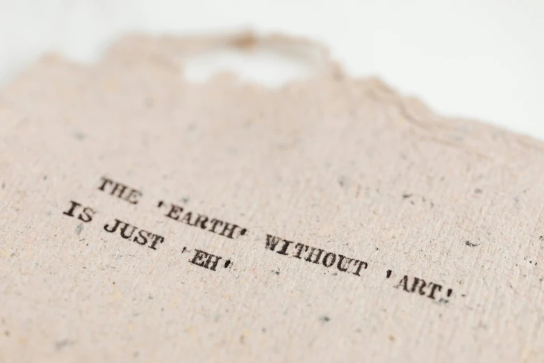 a close up of a piece of paper with writing on it, by Edward Clark, unsplash, arte povera, the earth, papercut, j. h. williams iii, set against a white background