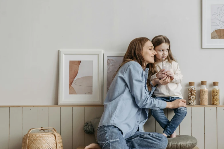 a woman and a little girl sitting on a bench, art & language, family framed on the wall, denim, profile image, sitting in a lounge