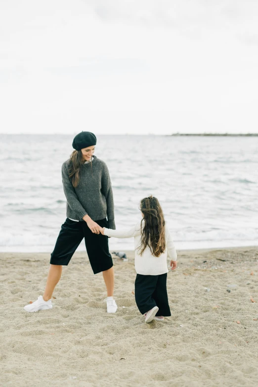 a mother and daughter playing frisbee on the beach, by Nina Hamnett, unsplash, minimalism, wearing a french beret, short puffy pants made of silk, with black beanie on head, boy shorts