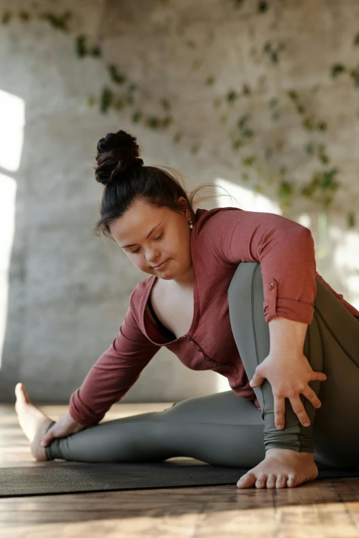 a woman doing a yoga pose on a wooden floor, a picture, pexels contest winner, renaissance, an overweight, looking across the shoulder, terracotta, grey