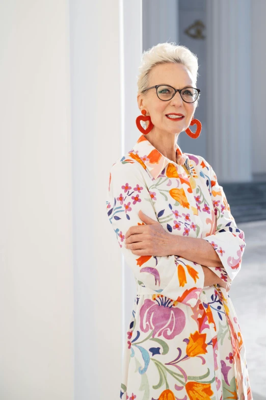 a woman in a floral dress posing for a picture, wearing square glasses, promotional image, barbara hammer, lifestyle