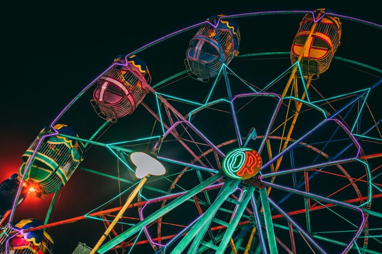 a ferris wheel is lit up at night, pexels contest winner, maximalism, day-glo colors, colorful]”, color image, album art