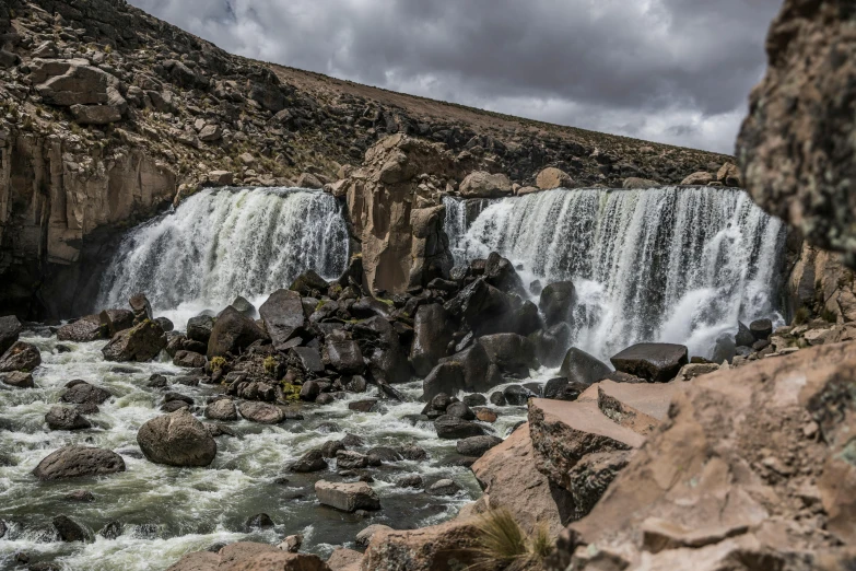 a waterfall that is in the middle of some rocks, by Daren Bader, pexels contest winner, hurufiyya, ivan bolivian, thumbnail, festivals, less detailing