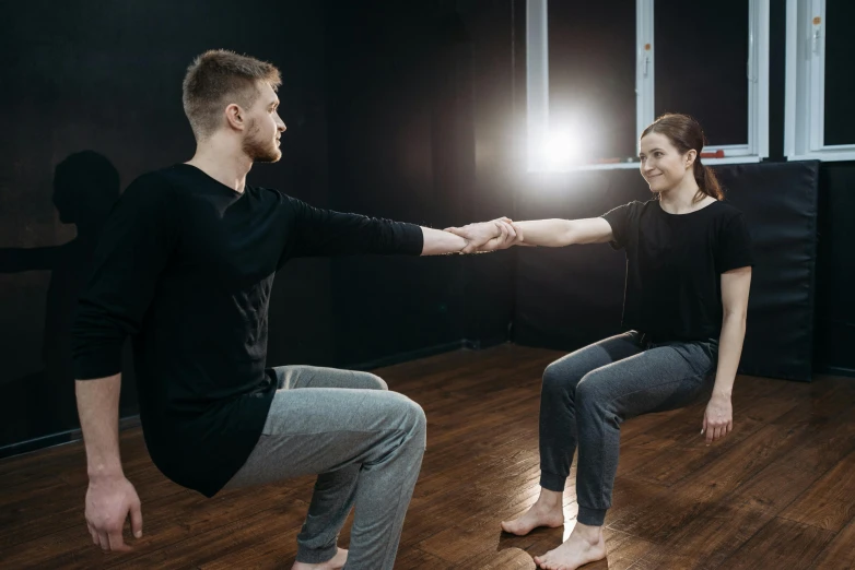 a man and a woman holding hands in a dance studio, unsplash, interactive art, sitting on bent knees, lachlan bailey, profile image, background image