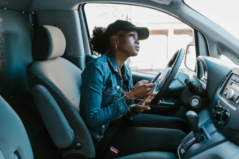 a woman sitting in the driver's seat of a car, by Carey Morris, pexels contest winner, maria borges, square, van, ergonomic