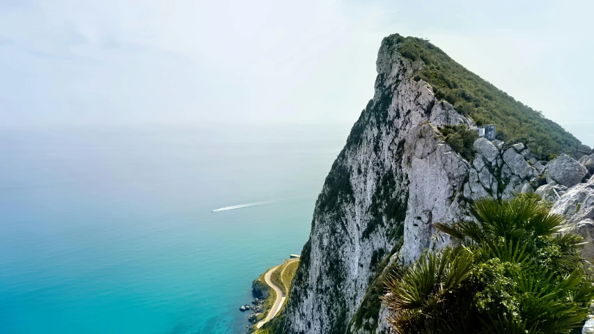 a man standing on top of a cliff next to the ocean, inspired by Thomas Struth, pexels contest winner, renaissance, “ aerial view of a mountain, chalk cliffs above, queen victoria, slim aarons