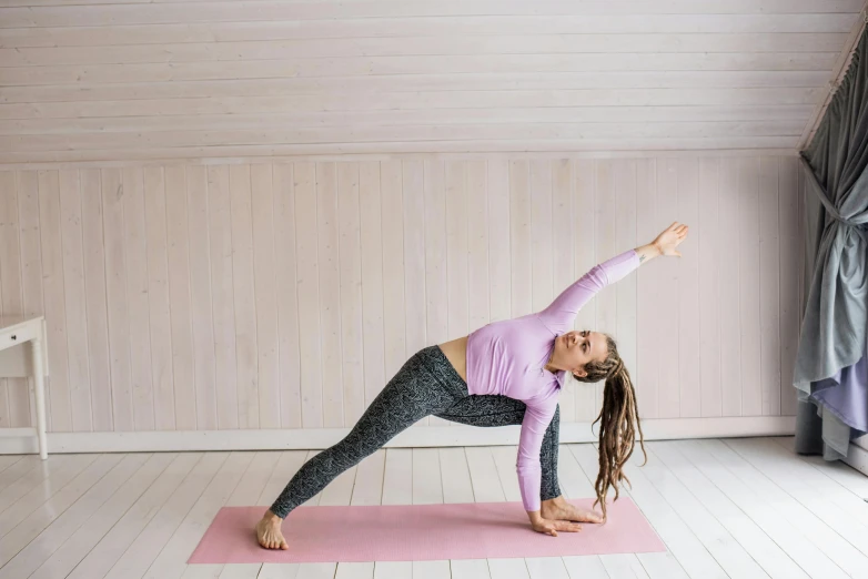 a woman doing a yoga pose on a pink mat, by Rachel Reckitt, pexels contest winner, brunette fairy woman stretching, as well as scratches, kami, t pose