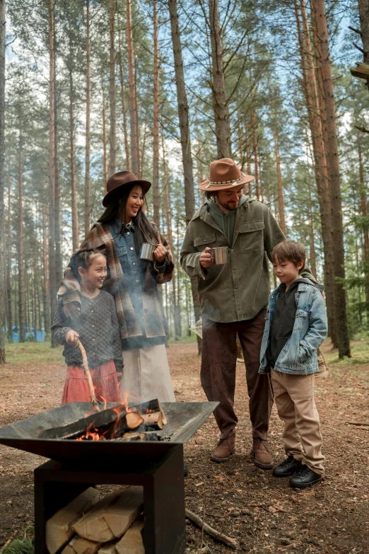 a group of people standing around a fire in the woods, of a family standing in a park, woodlands style, explorer, brown