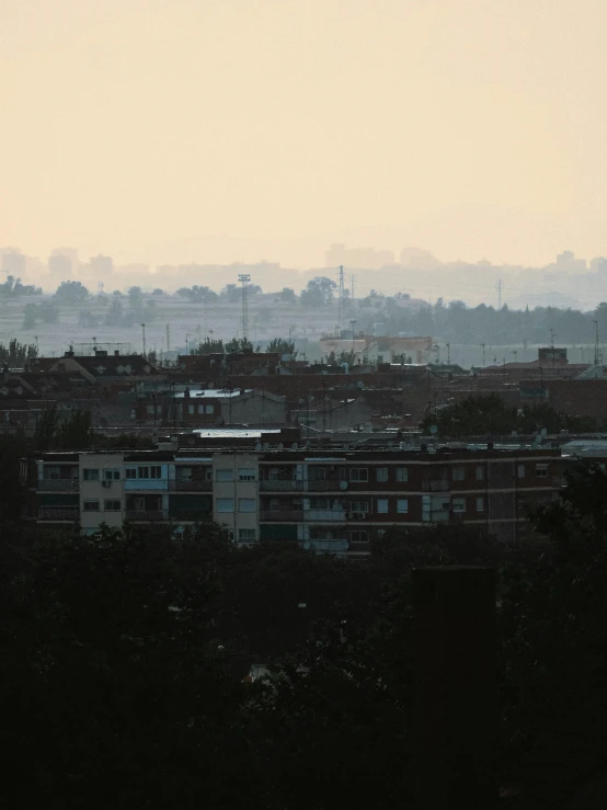 a view of a city from the top of a hill, inspired by Elsa Bleda, faded and dusty, photograph taken in 2 0 2 0, humid evening, medium-shot