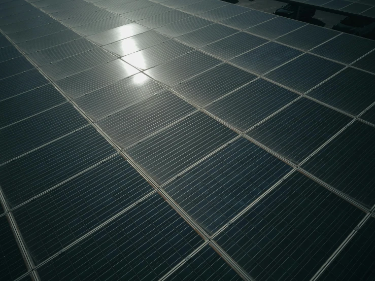 a group of solar panels sitting on top of a roof, by Xul Solar, pexels contest winner, bauhaus, 8 k. volumetric lighting. dark, square lines, high angle close up shot, metal floor