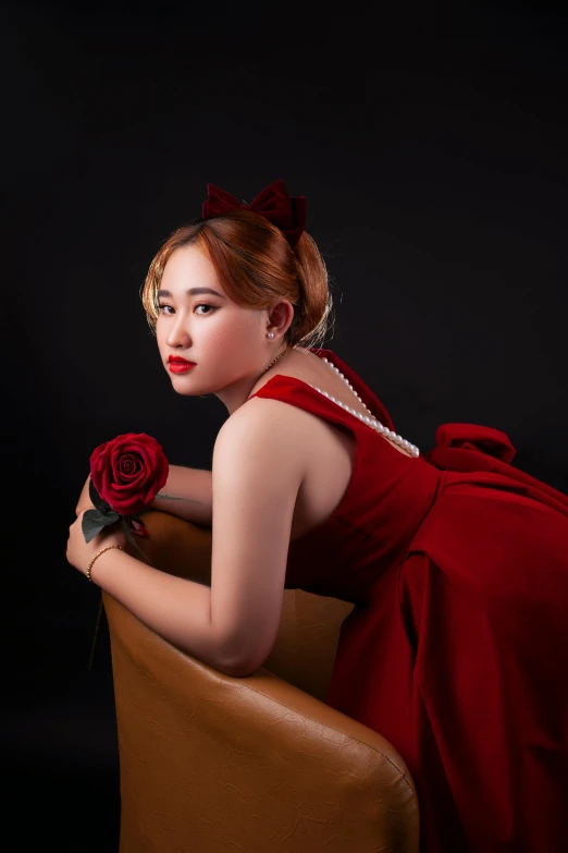 a woman in a red dress sitting on a chair, an album cover, inspired by Rudy Siswanto, realism, glamourous cosplay, profile image, red rose, colour corrected