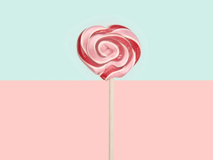 a heart shaped lollipop sitting on top of a pink and blue background, inspired by Yanjun Cheng, pexels, ffffound, clemens ascher, snail, edible
