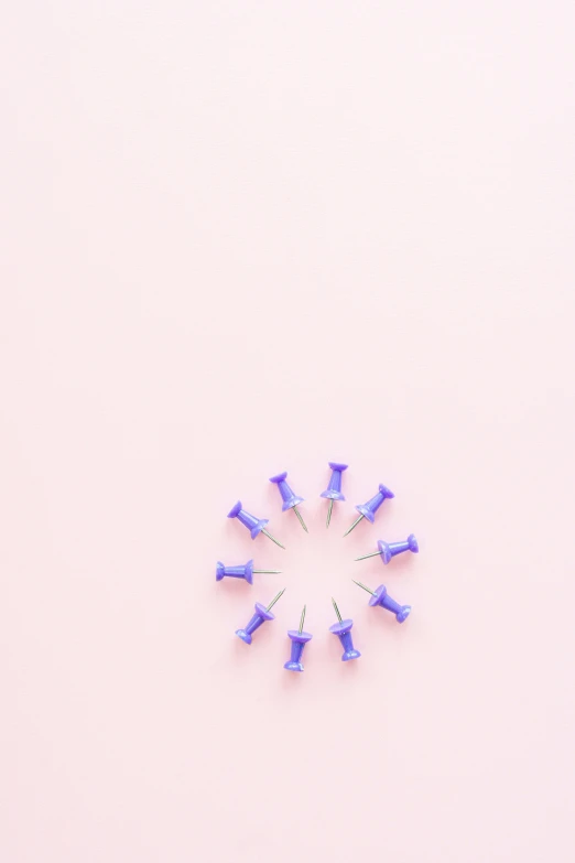 a group of toothbrushes arranged in a circle on a pink background, an album cover, by Nicolette Macnamara, trending on pexels, postminimalism, screws, blue and violet, small studded earings, 9