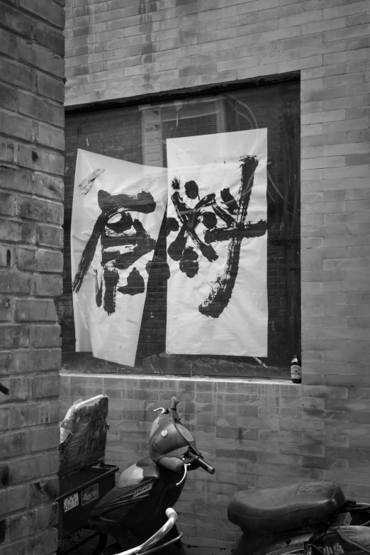 a motor scooter parked in front of a brick building, a silk screen, inspired by Xu Wei, ((portrait)), estrange calligraphy, shop window for magical weapons, monochrome bw