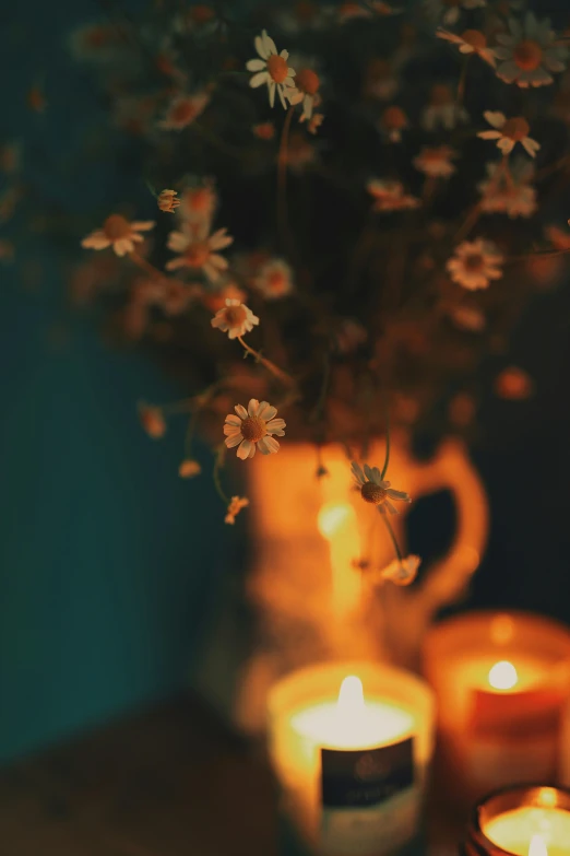 a bunch of candles sitting on top of a table, a still life, inspired by Elsa Bleda, trending on unsplash, romanticism, field of flowers at night, retro stylised, fall season, vase with flowers