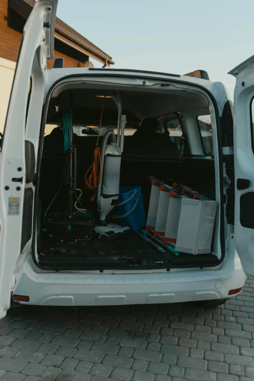 a white van parked in front of a house, inside of a car, thievery equipment, square, clean and organized