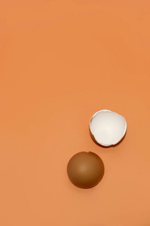 a couple of eggs sitting on top of a table, by Alison Geissler, essence, top - down photograph, kek, skin color