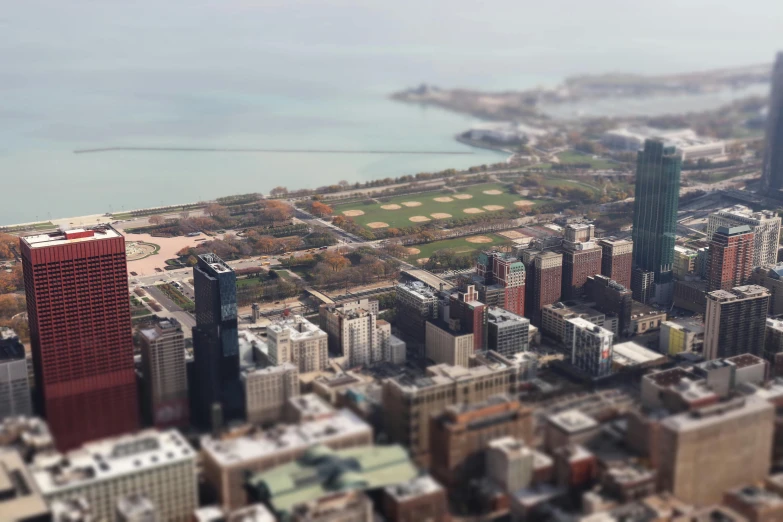 a view of a city from the top of a building, a tilt shift photo, pexels contest winner, photorealism, chicago, parks and lakes, very sparse detail, ground - level medium shot