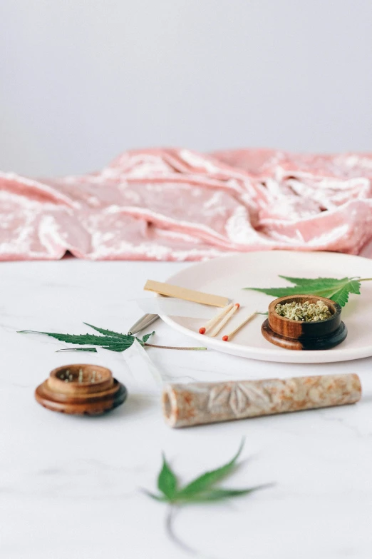 a close up of a plate of food on a table, a still life, by Julia Pishtar, trending on unsplash, marijuana smoke, pastel pink robes, made of bamboo, miniature product photo