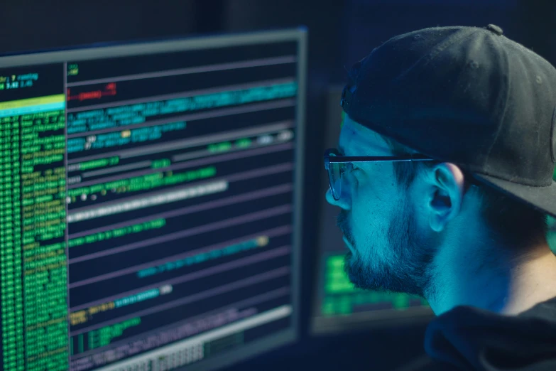 a man sitting in front of a computer monitor, a digital rendering, by Adam Marczyński, pexels, hacking into the mainframe, operation, 2 5 6 x 2 5 6 pixels, a close-up