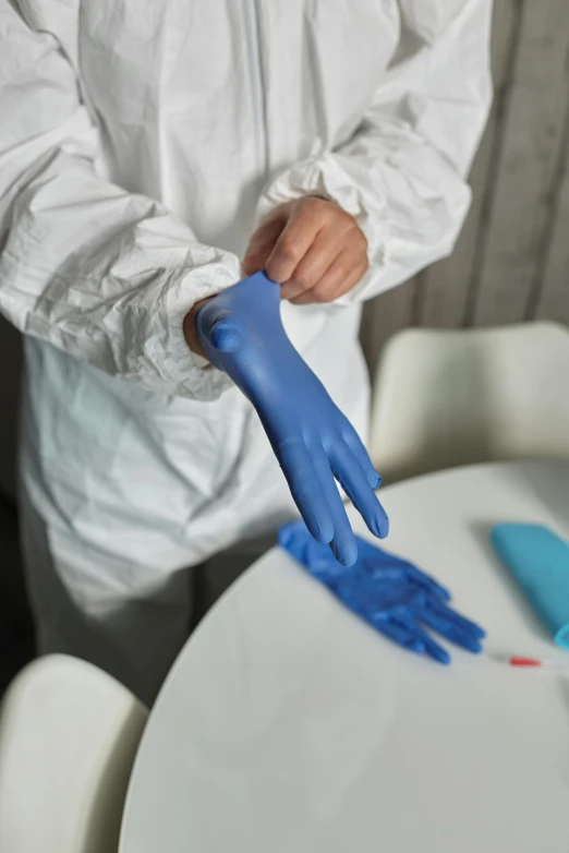 a person in a white shirt and blue gloves, on a white table, wearing gloves, soft volume absorbation, thumbnail
