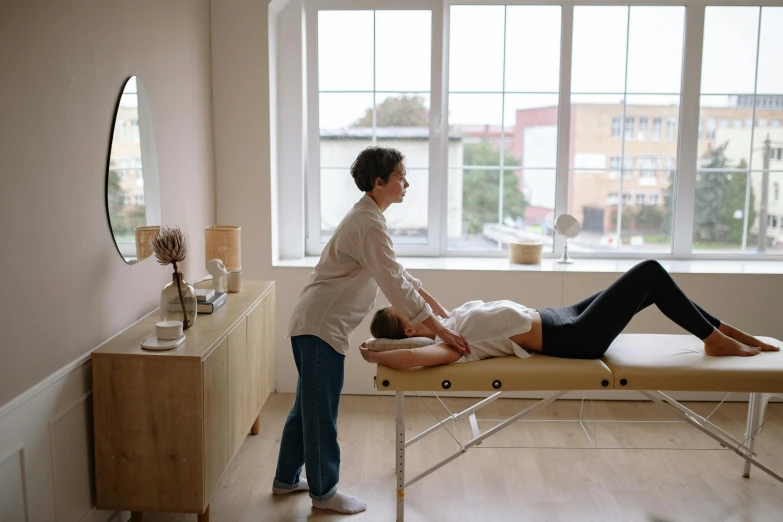 a woman getting a massage in a room, sanja stikovic, white limbo, on a white table, multiple stories