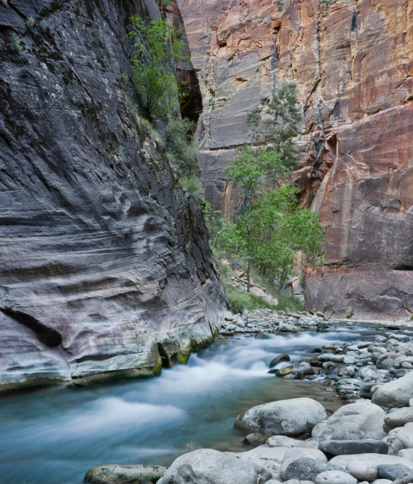 a river running through a canyon surrounded by rocks, rock walls, rippling water, subtle detailing, sam shearon