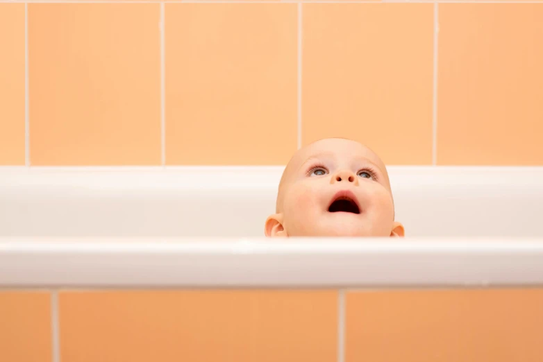 a close up of a baby in a bath tub, by Joe Bowler, looking upwards, scientific, backdrop, surprised