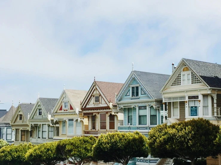 a row of houses sitting on the side of a road, by Carey Morris, pexels contest winner, art nouveau, cupertino, wes anderson movie, exterior view, sustainable materials