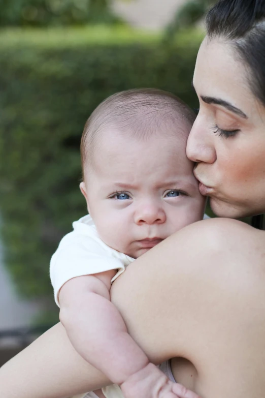 a woman holding a baby in her arms, pexels, sad grumpy face, square, scientific photo, tummy