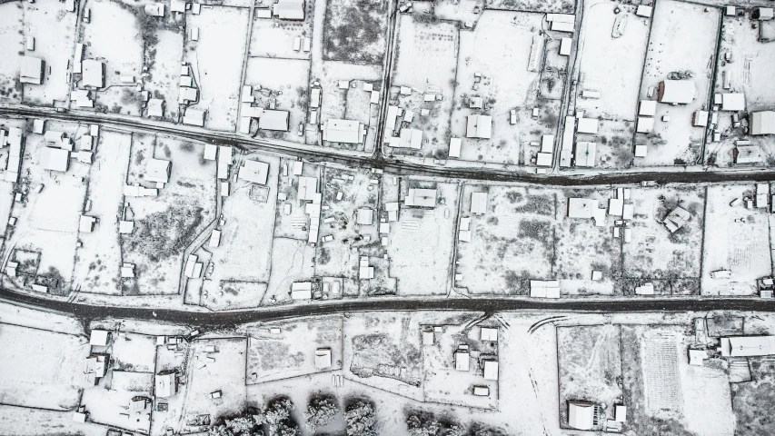 a black and white photo of an aerial view of a city, an ultrafine detailed painting, ground covered with snow, sanjulian. detailed texture, nekro petros afshar, mapbox