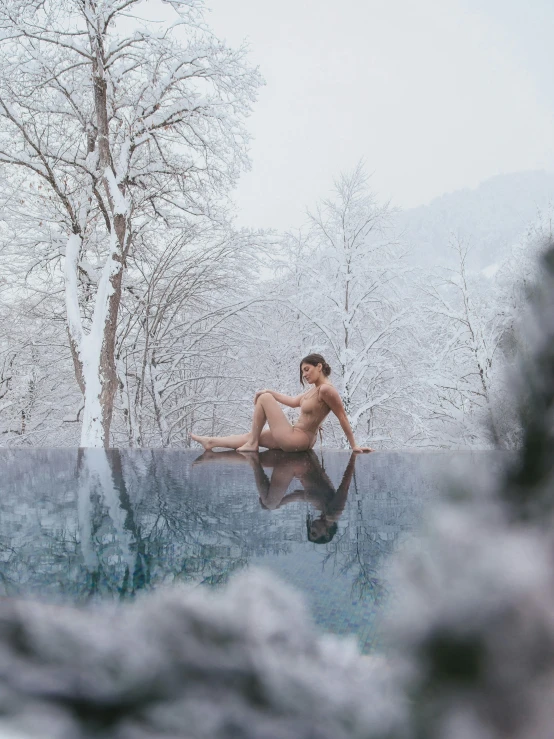 a naked man sitting on the edge of a pool, a picture, by Kristian Zahrtmann, unsplash contest winner, in a snowy forest setting, 🎀 🍓 🧚, panoramic view of girl, 5 0 0 px models