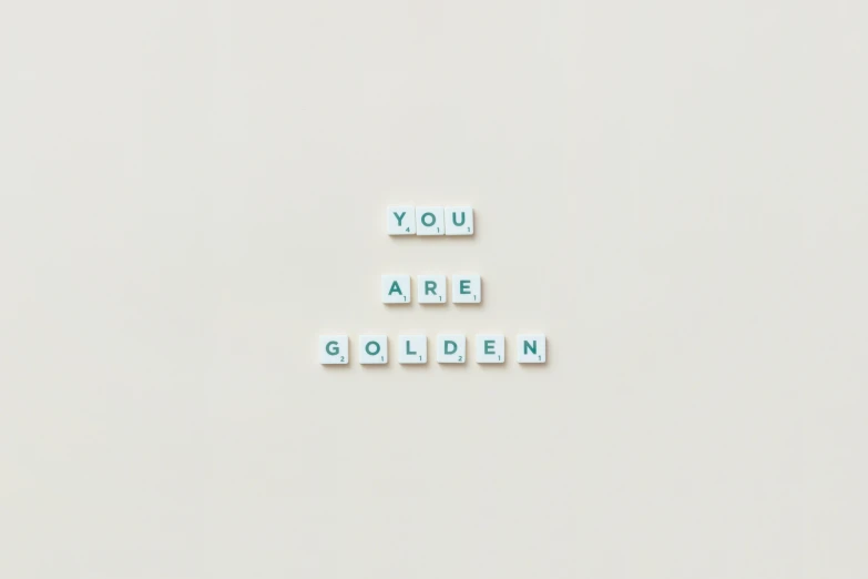 a white wall with the words you are golden written on it, a photo, minimalism, golden miniatures, healthcare, y2k, goldenwolf