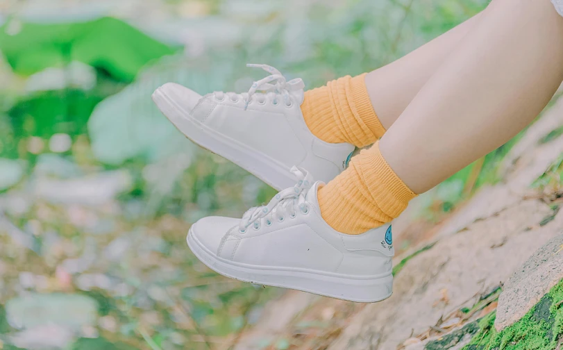 a close up of a person's legs wearing white sneakers, inspired by Elsa Bleda, pexels contest winner, yellow theme, young and cute girl, avatar image, ulzzang