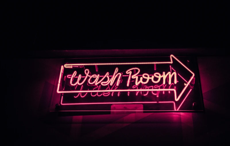 a neon sign hanging from the side of a building, unsplash contest winner, in bathroom, washy brush, clean room, magenta