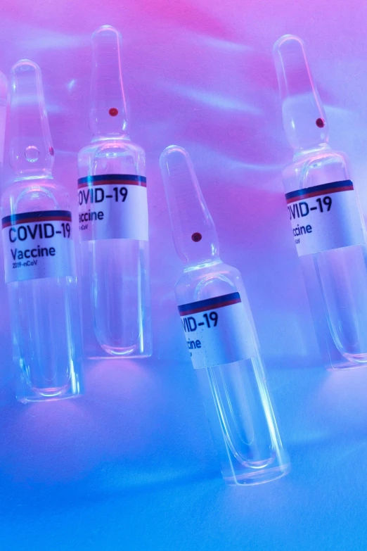 a group of vials sitting on top of a table, purple and blue neons, medical labels, thumbnail, feature