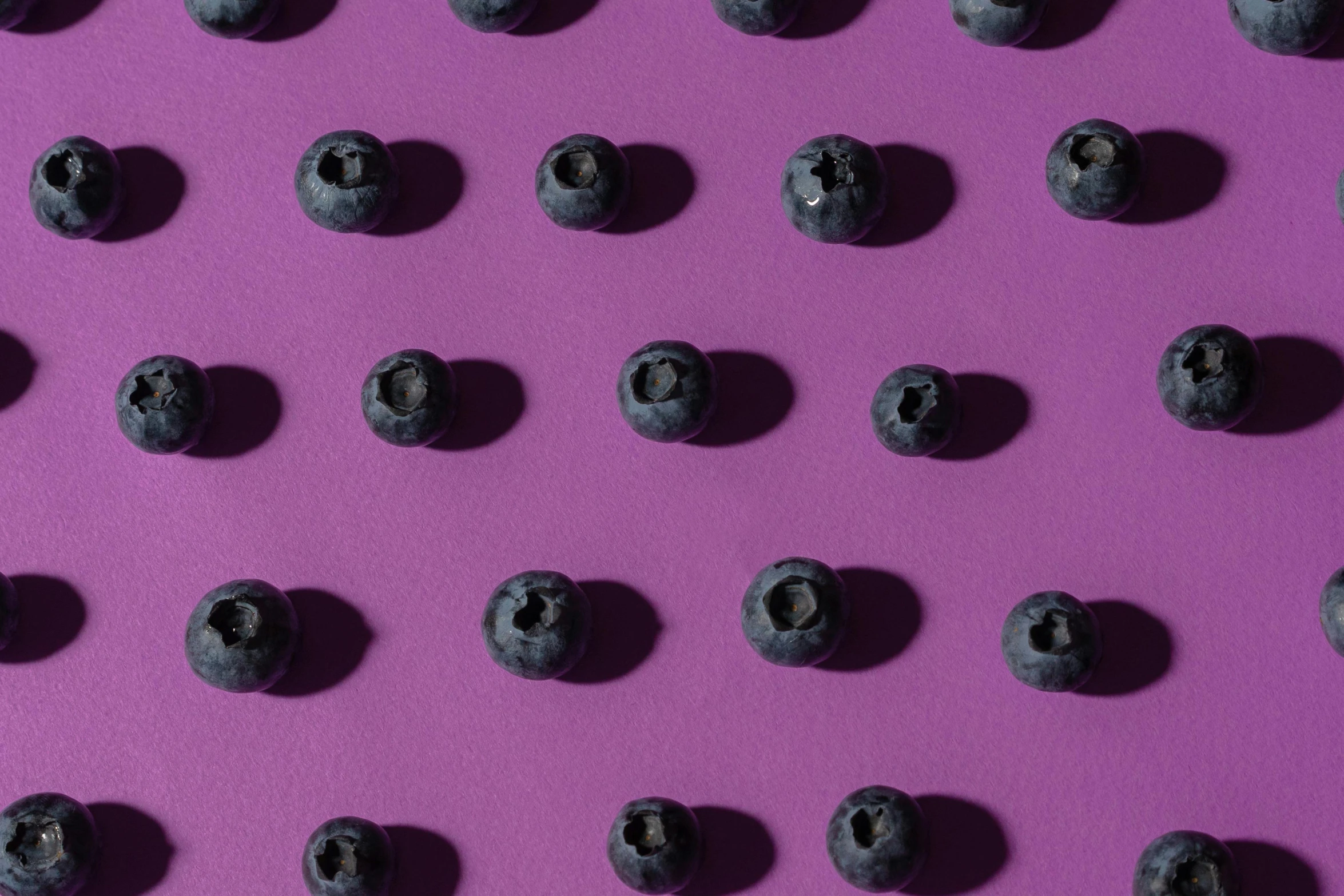 a bunch of blueberries sitting on top of a purple surface, trending on pexels, pop art, background image, tileable, bullet holes, patterned