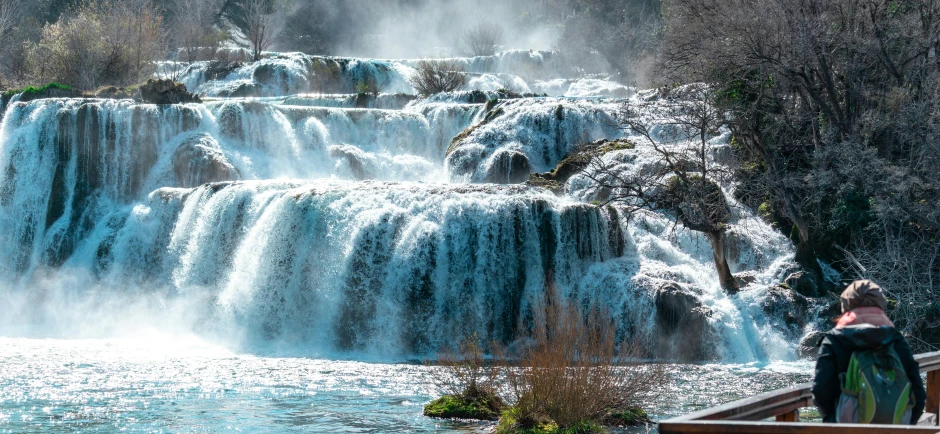 a couple of people that are standing in front of a waterfall, white travertine terraces, fishing, header, stacked image