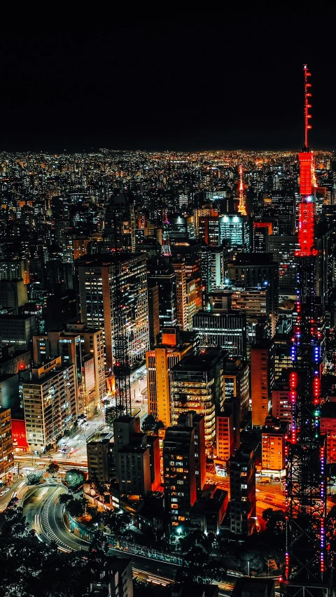 an aerial view of a city at night, by Adam Manyoki, pexels contest winner, ukiyo-e, red - yellow - blue building, skyline, 8 k hi - res, stacked city