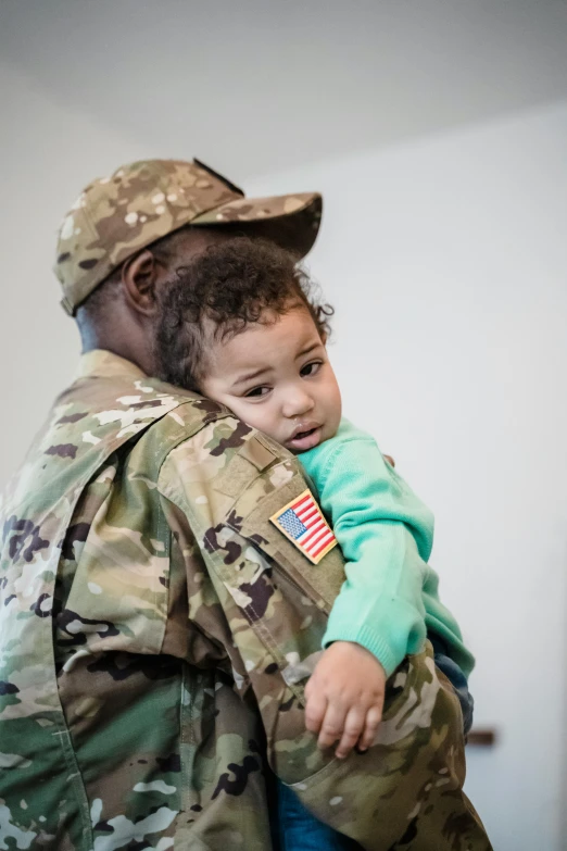 a soldier holding a child in his arms, slide show, square, gen z, patterned