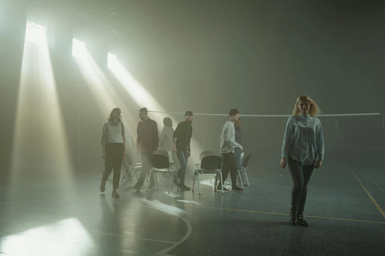 a group of people standing on top of a basketball court, a hologram, antipodeans, moody hazy lighting, on set, leaving a room, ( ( theatrical ) )