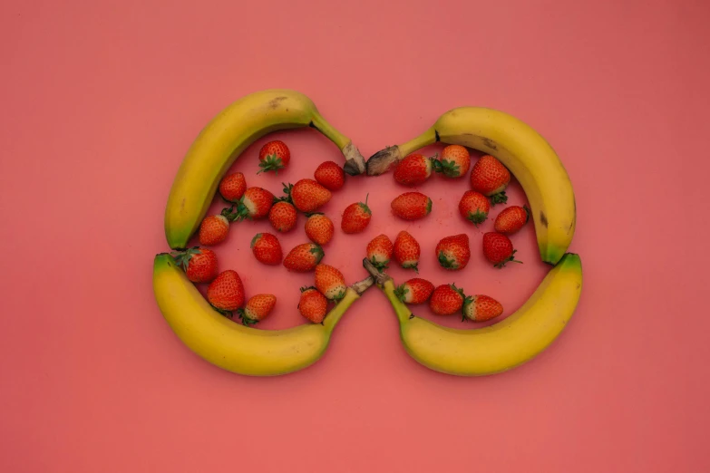 a couple of bananas and some strawberries on a pink surface, by Adam Marczyński, pexels contest winner, yinyang shaped, infinity symbol, kidneys, contracept