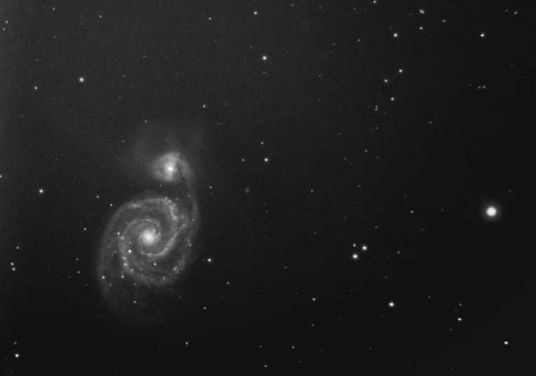 a black and white photo of a spiral galaxy, a portrait, album photo, side front view, taken on a 2010s camera, 2 4 0 p footage