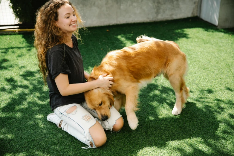 a woman sitting on the ground petting a dog, pexels contest winner, lawn, thumbnail, aussie, 1 2 9 7