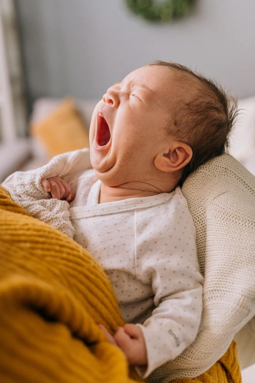 a close up of a person holding a baby, yawning, reclining, highly upvoted, bedhead