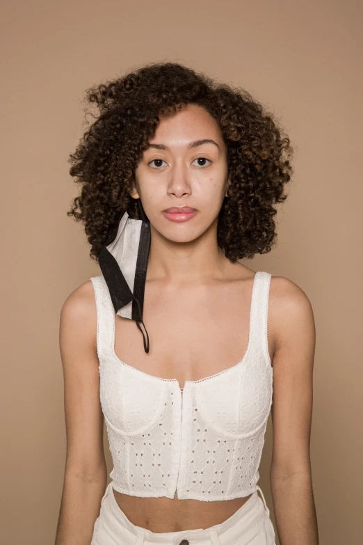 a woman with a tie around her neck, an album cover, inspired by Esaias Boursse, trending on pexels, wearing white camisole, mixed race, nonbinary model, photo taken in 2018