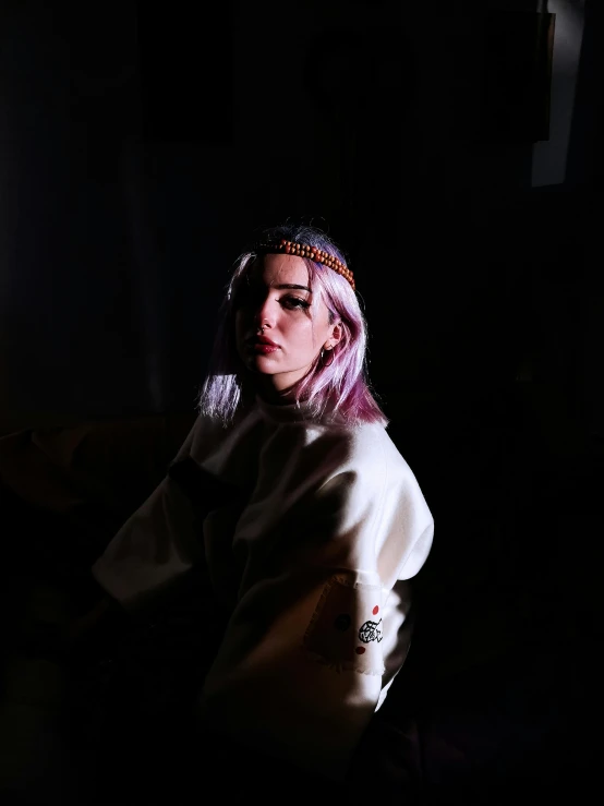 a woman sitting on a couch in the dark, a portrait, inspired by Elsa Bleda, unsplash, visual art, wearing a pink head band, 4k hd. snow white hair, wearing a purple detailed coat, 🤤 girl portrait