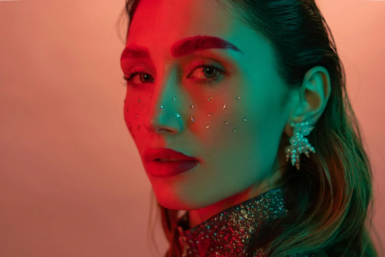 a woman with glitter on her face, an album cover, by Julia Pishtar, trending on pexels, gemma chan girl portrait, olivia culpo, red neon details, telephoto shot